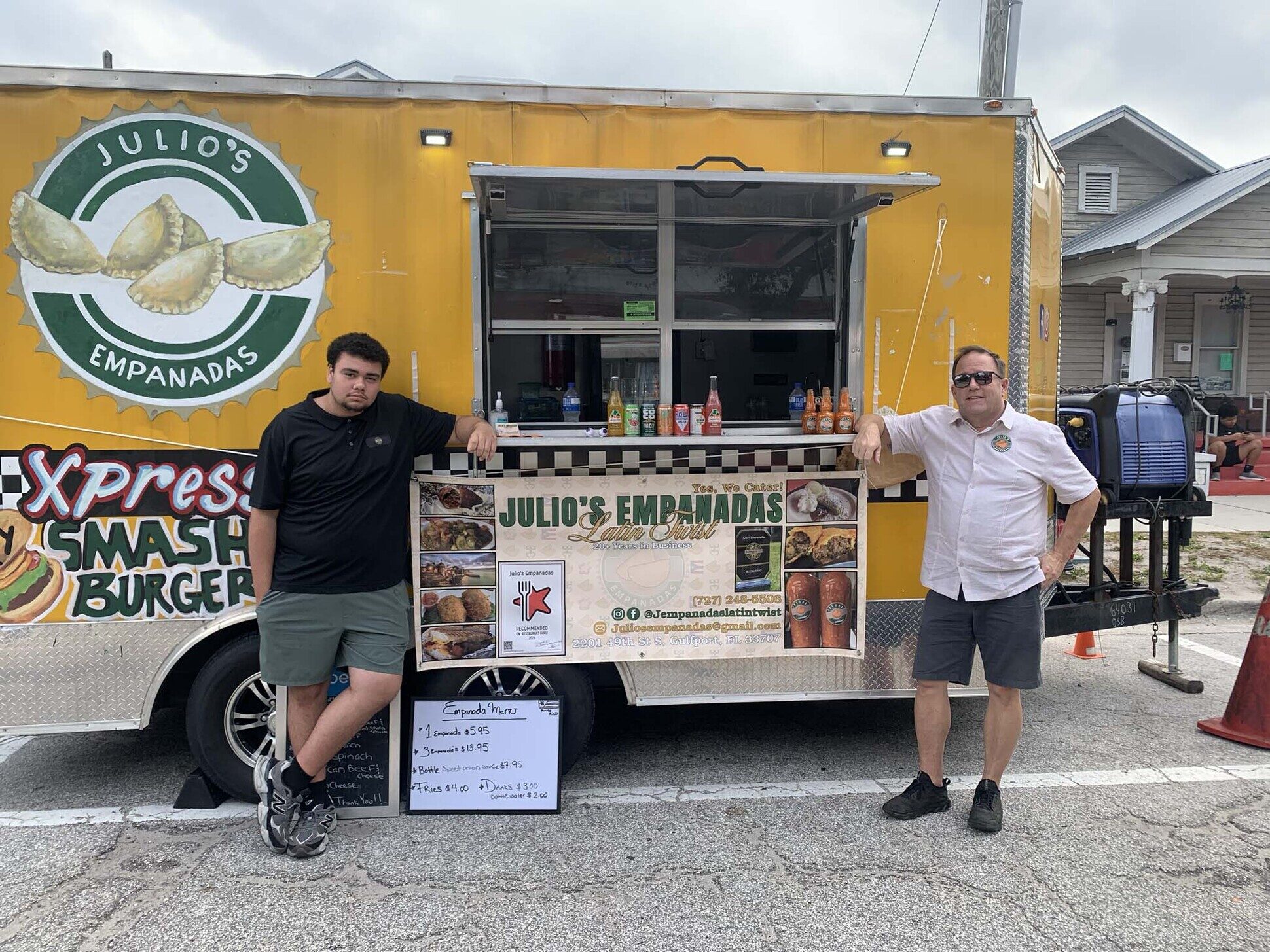 Julio's food truck serving a line of locals at a community event