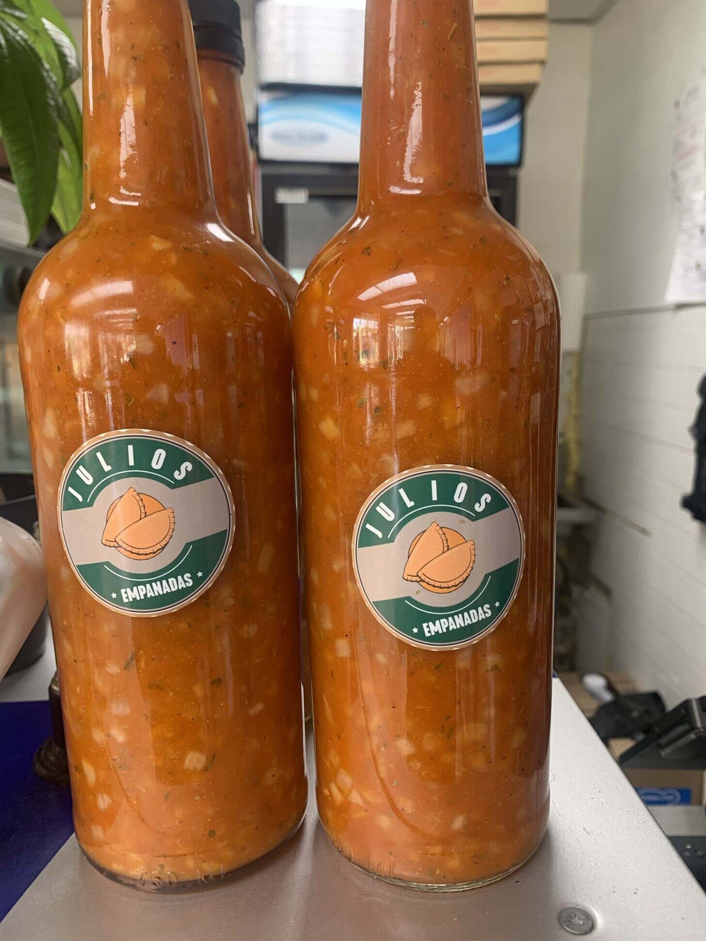 Two Julio's Empanadas branded sauce bottles side by side