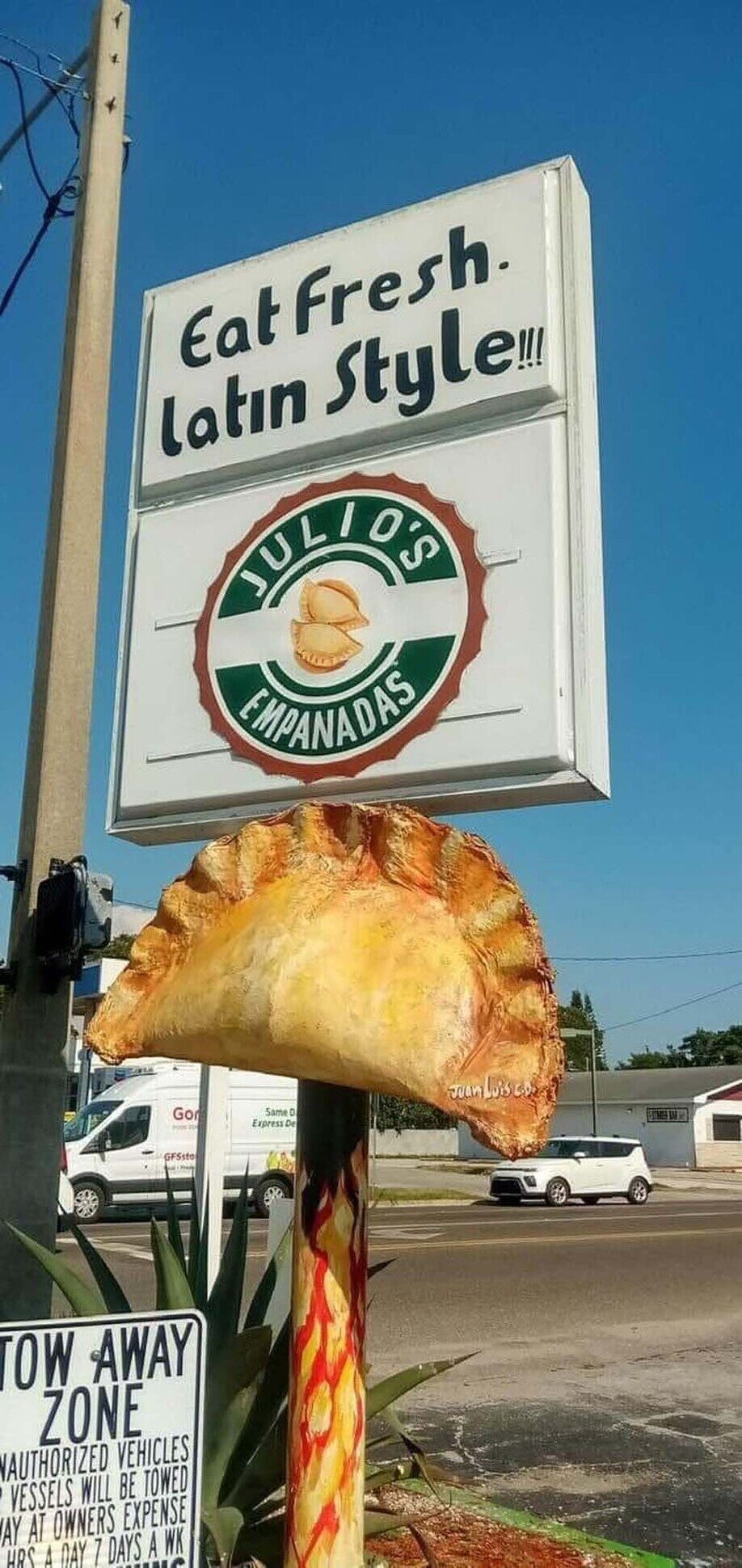 The Julio's Empanadas street-level sign on 49th Street in Gulfport